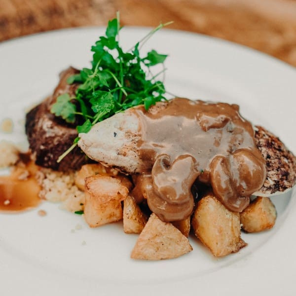 Plated main meals. Chicken breast with a creamy mushroom sauce. Find all our delicious menu choices on our website.