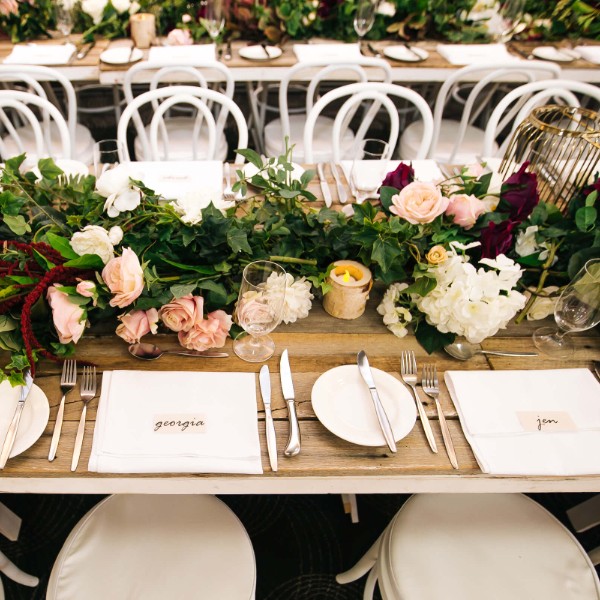 Long timber trestle tables setup for a wedding at Mulgrave Country Club
