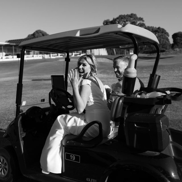 Bride and groom in golf cart