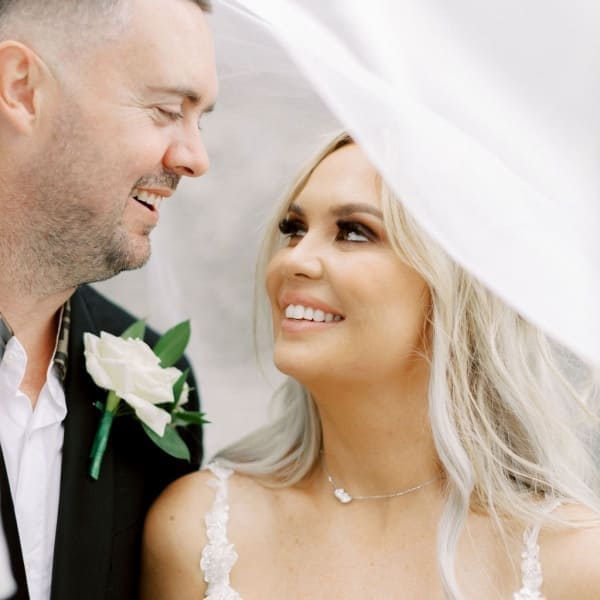 Bride and groom under a veil