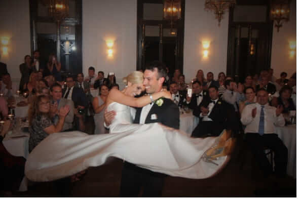 Bride and Groom's first Dance with the Groom joyfully spinning his bride in his arms.
