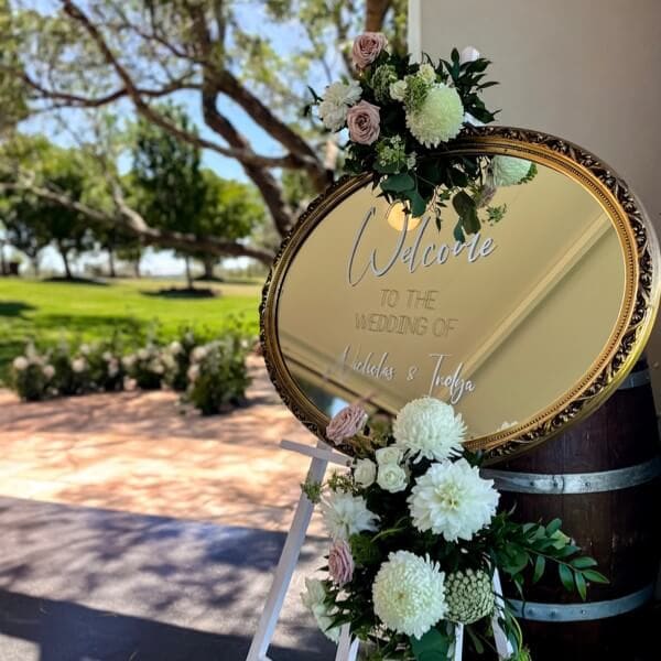 Welcome signage with floor arbour in the background
