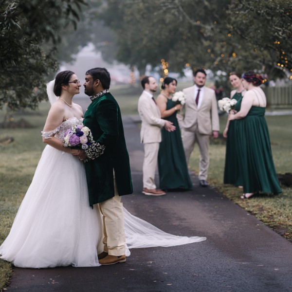 bride and groom in front of wedding party