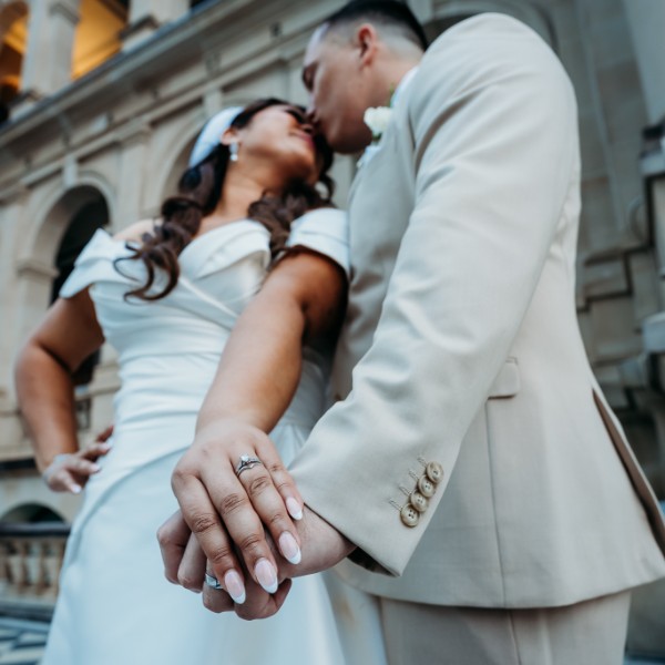 bride and groom showing their rings