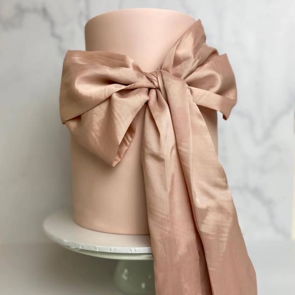 Dusty pink wedding cake with silk bow by SuperEgo Cakes