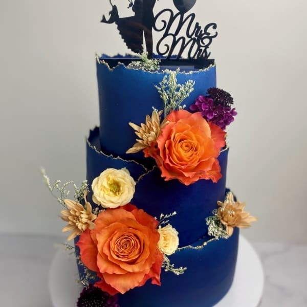 Blue wedding cake with orange florals by SuperEgo Cakes