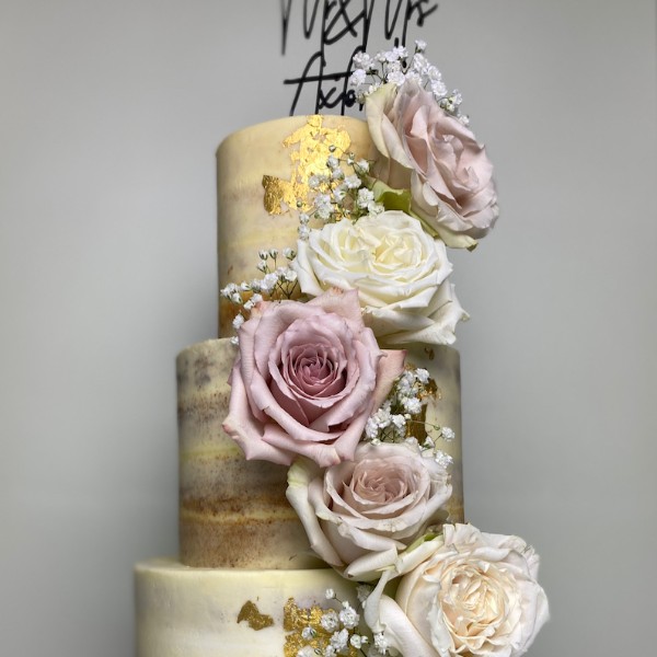 Semi-naked cake with gold leaf and fresh roses