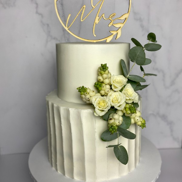 White wedding cake with textured buttercream and fresh florals by SuperEgo Cakes