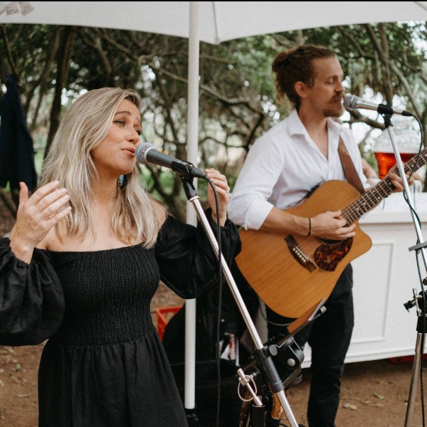 Bec and Oscar sing relaxed background music as guests arrive at a Noosa Beach wedding ceremony