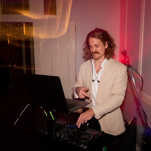 Oscar DJing lively music as guests dance at Toowoomba wedding reception